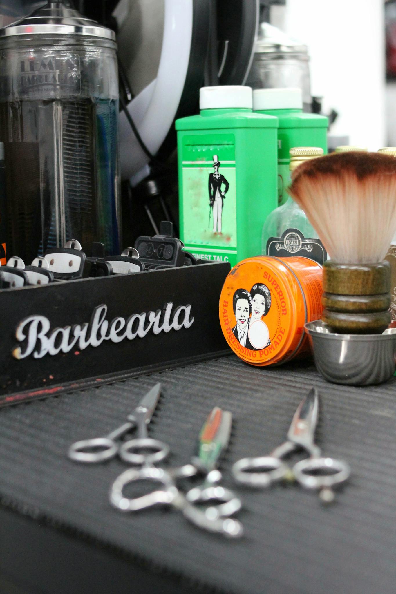 Vintage barber shop tools including clippers, scissors, and grooming products in São Paulo.